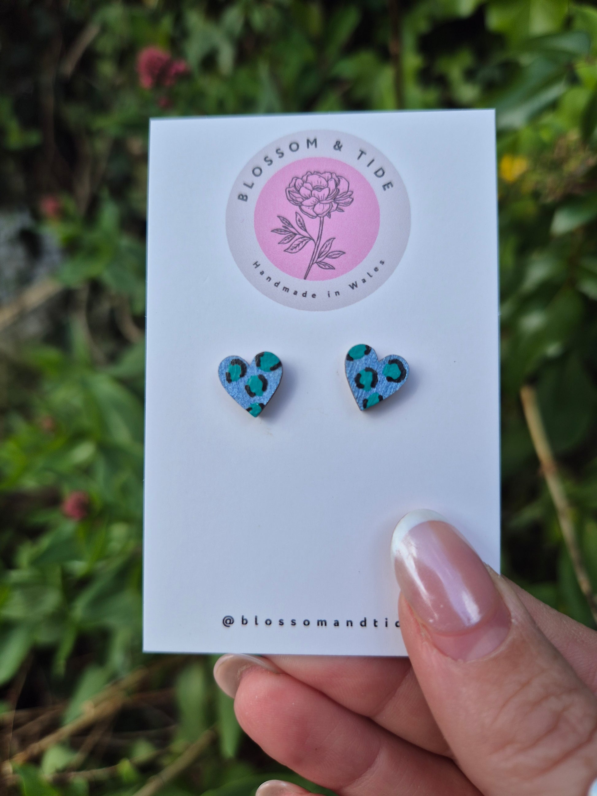 Hand painted metallic animal print heart shaped stud earrings on blossom and tide branded earring card 
