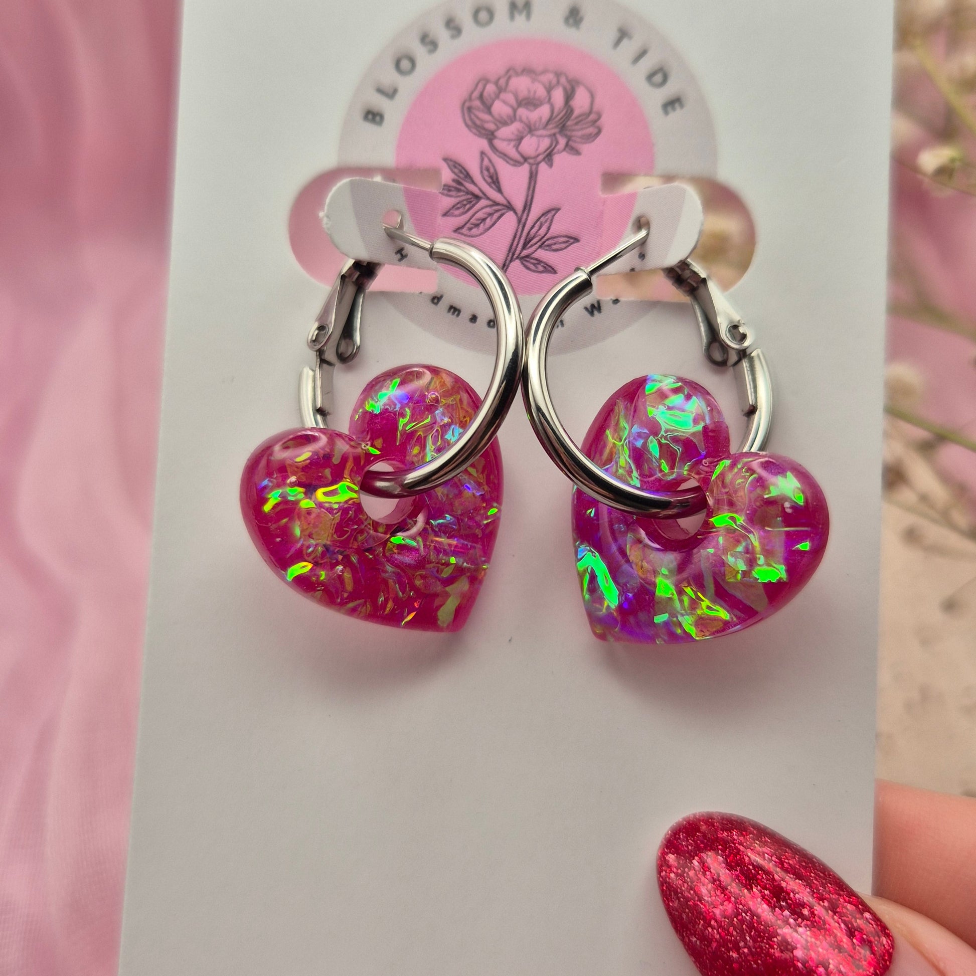 Valentine’s Day earrings featuring pink hearts and modern hoops.
