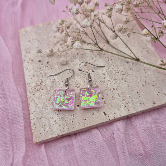 Triangle-shaped statement earrings reflecting colourful light, handmade in Wales