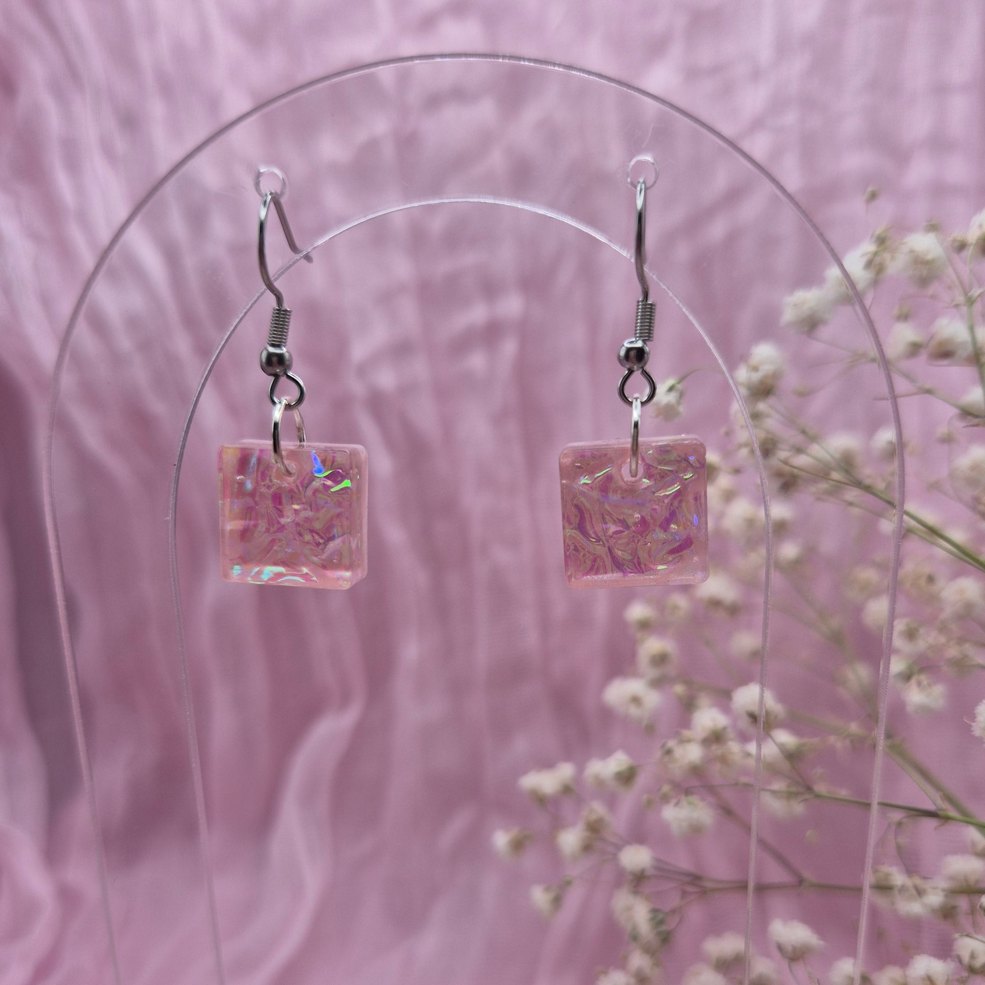 Triangle-shaped statement earrings reflecting colourful light, handmade in Wales