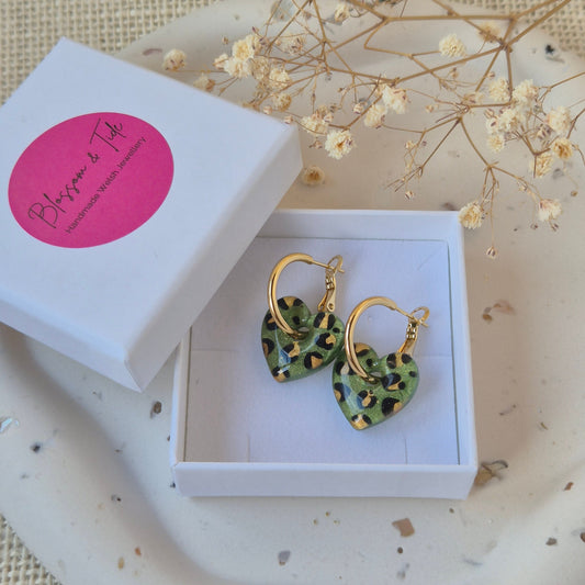 Olive green leopard print heart earrings on gold hoop in a branded 'blossom and tide'  box against a neutral background