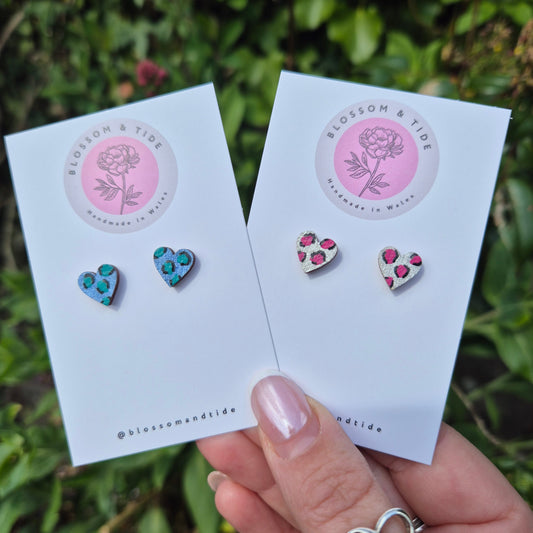 Hand painted metallic animal print heart shaped stud earrings on blossom and tide branded earring card 