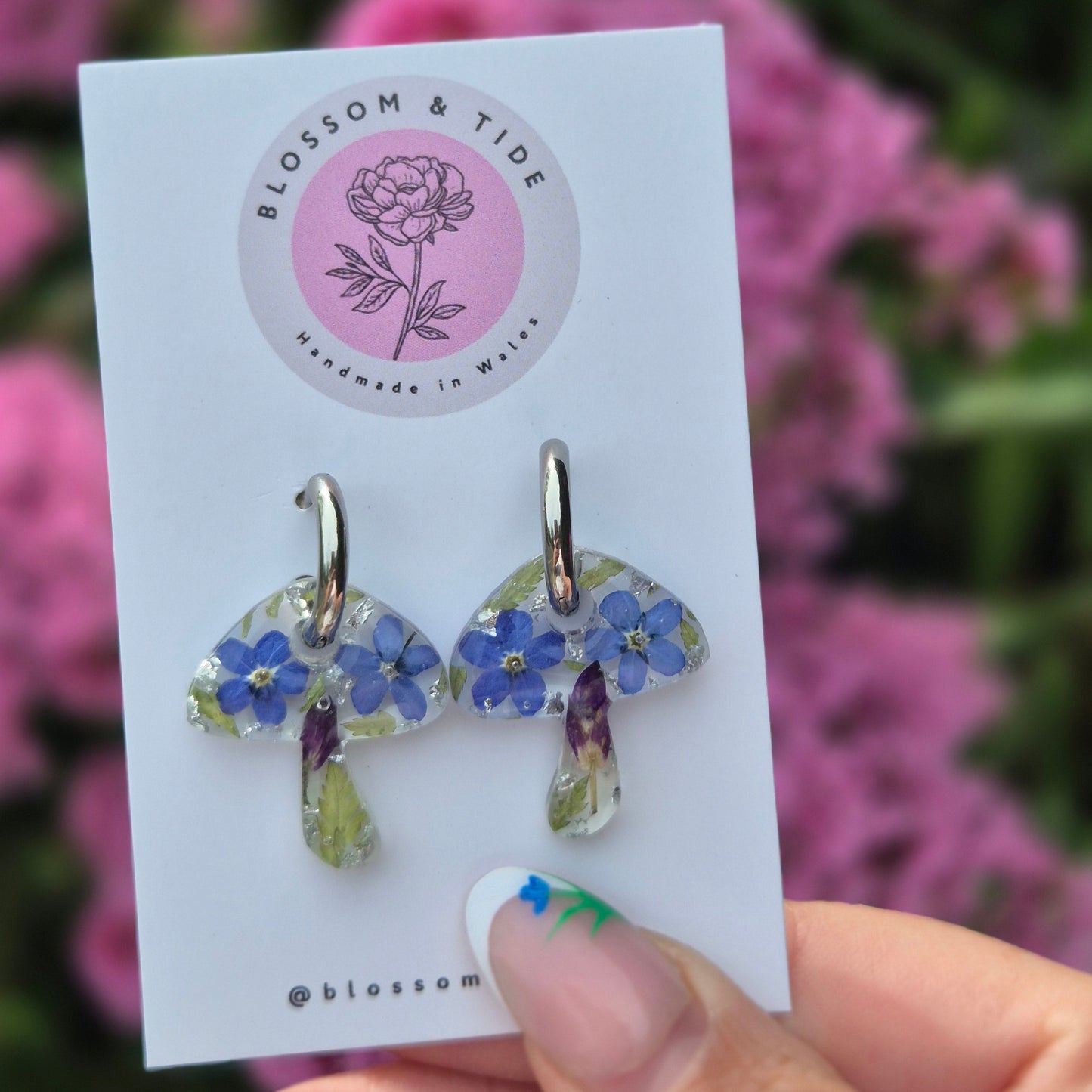 mushroom shaped earrings with real pressed forget-me-nots on silver stainless steel hoops