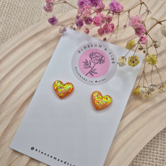Heart-shaped stud earrings on branded display card, presented in an organza gift bag