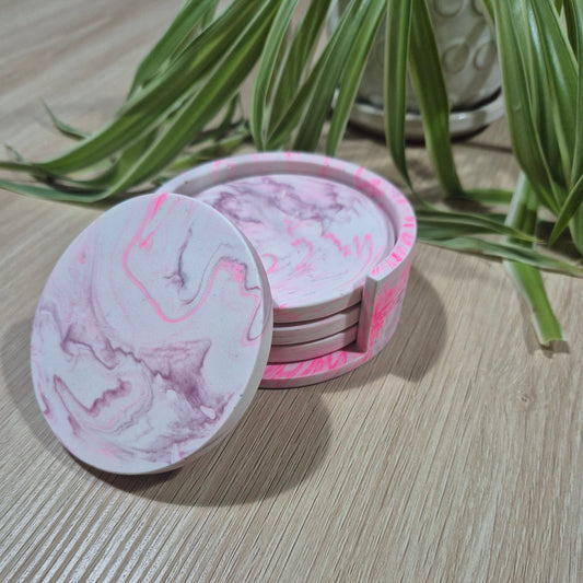 Set of 4 pink and purple marbled coasters in matching holder.