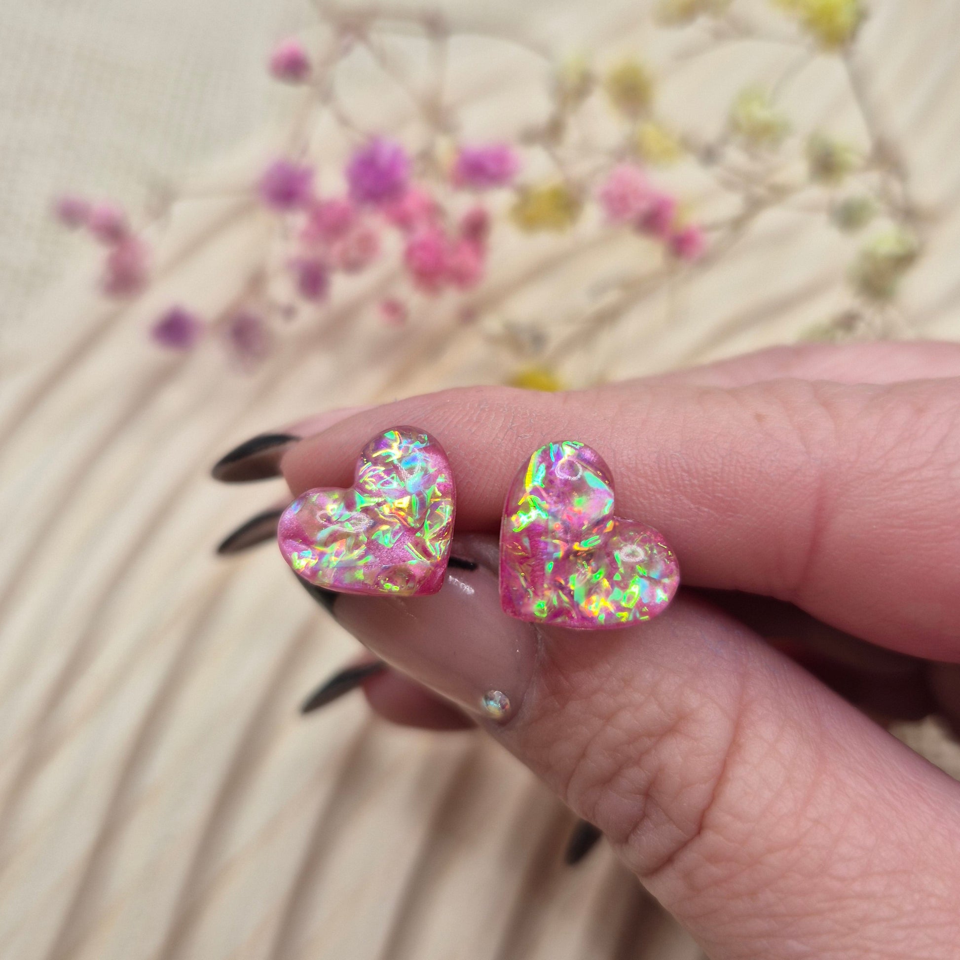 Holographic resin earrings catching the light, ideal for romantic or everyday wear