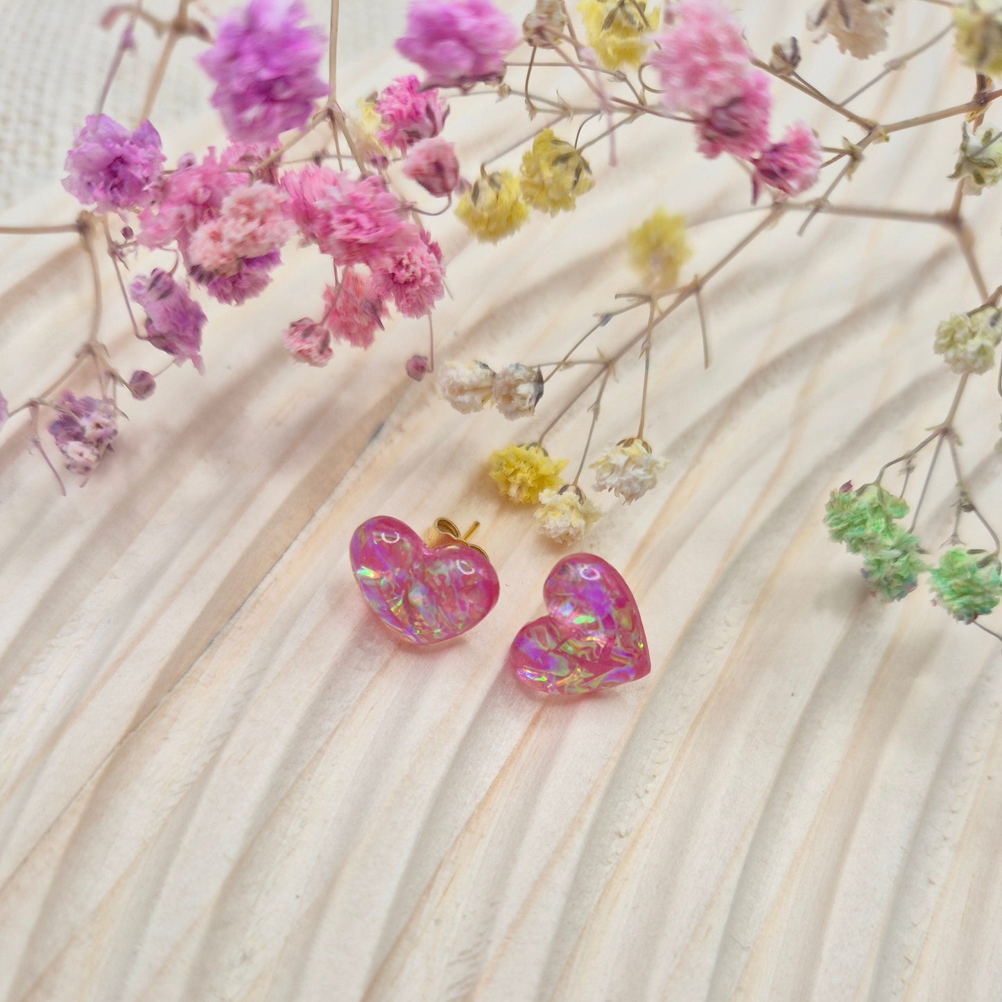 Holographic resin earrings catching the light, ideal for romantic or everyday wear