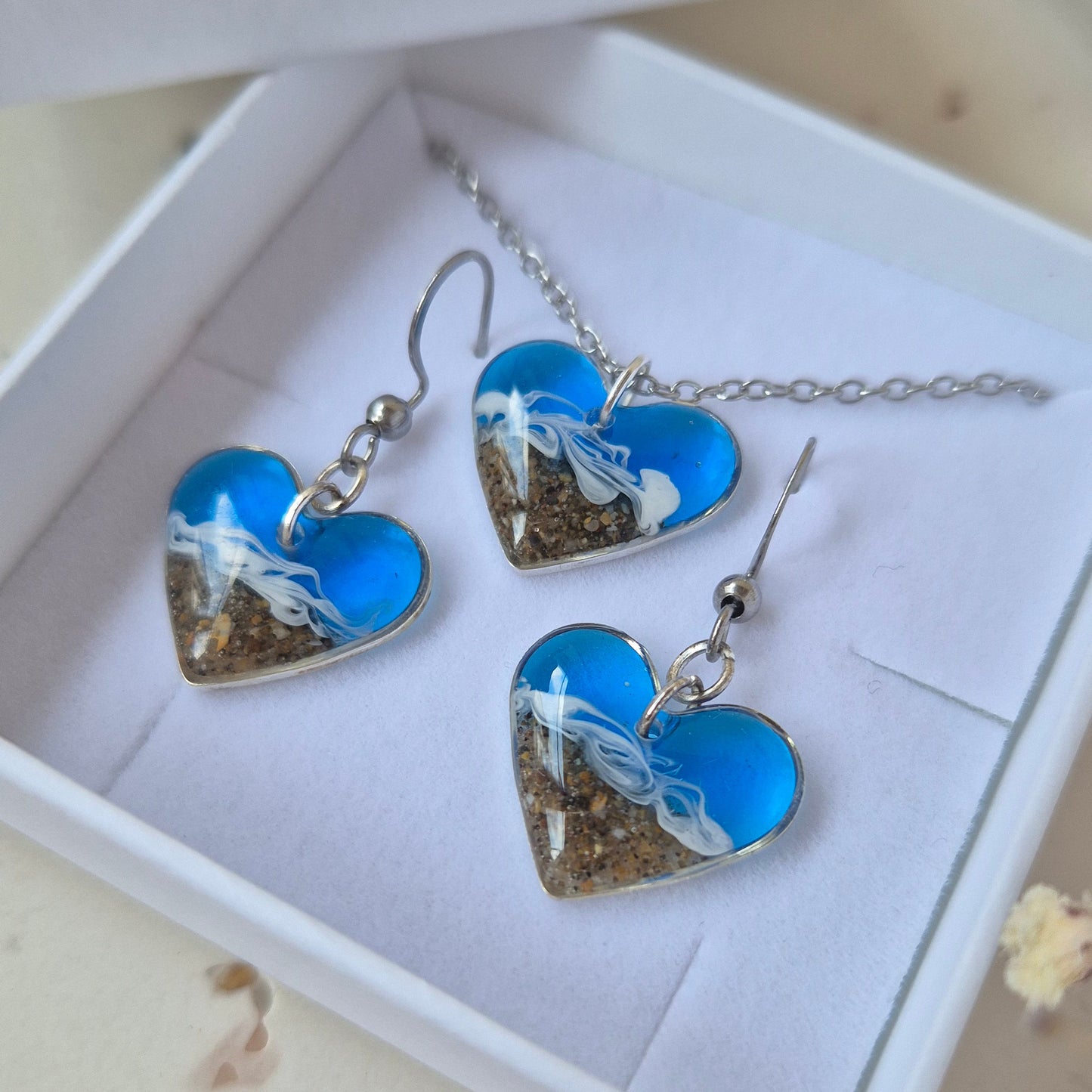 Heart-shaped blue and silver welsh beach jewelry set in a white box