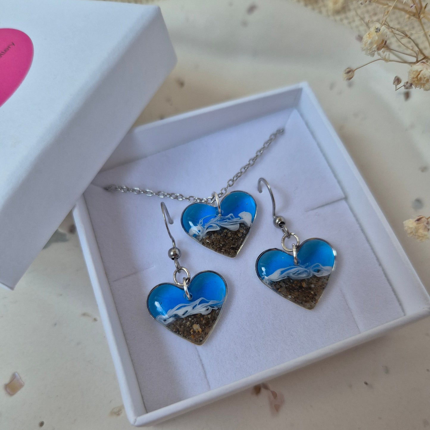 Blue and silver welsh beach jewelry set in a white box on a light background