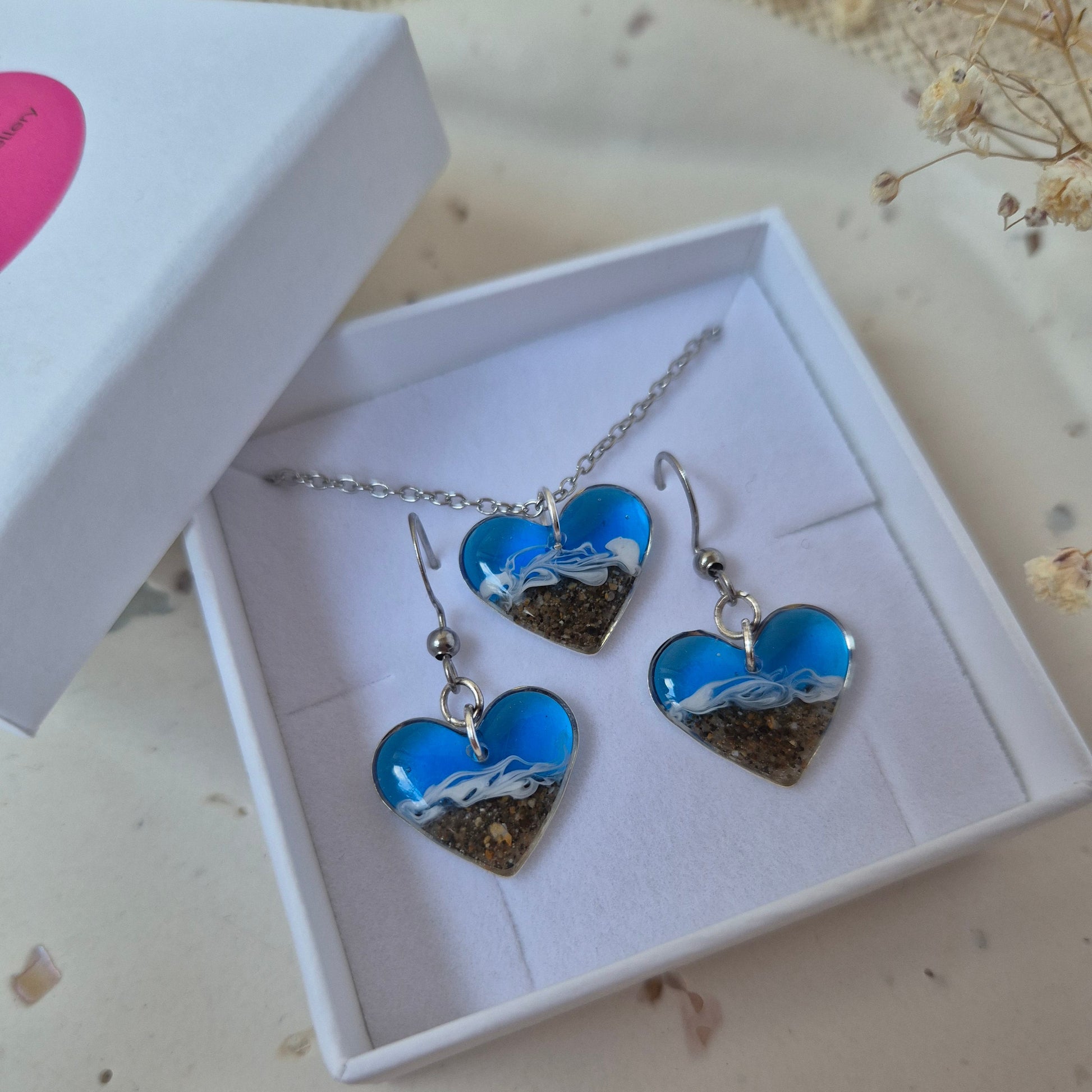 Blue and silver welsh beach jewelry set in a white box on a light background